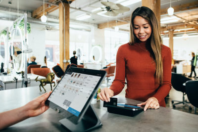 woman checking out at register